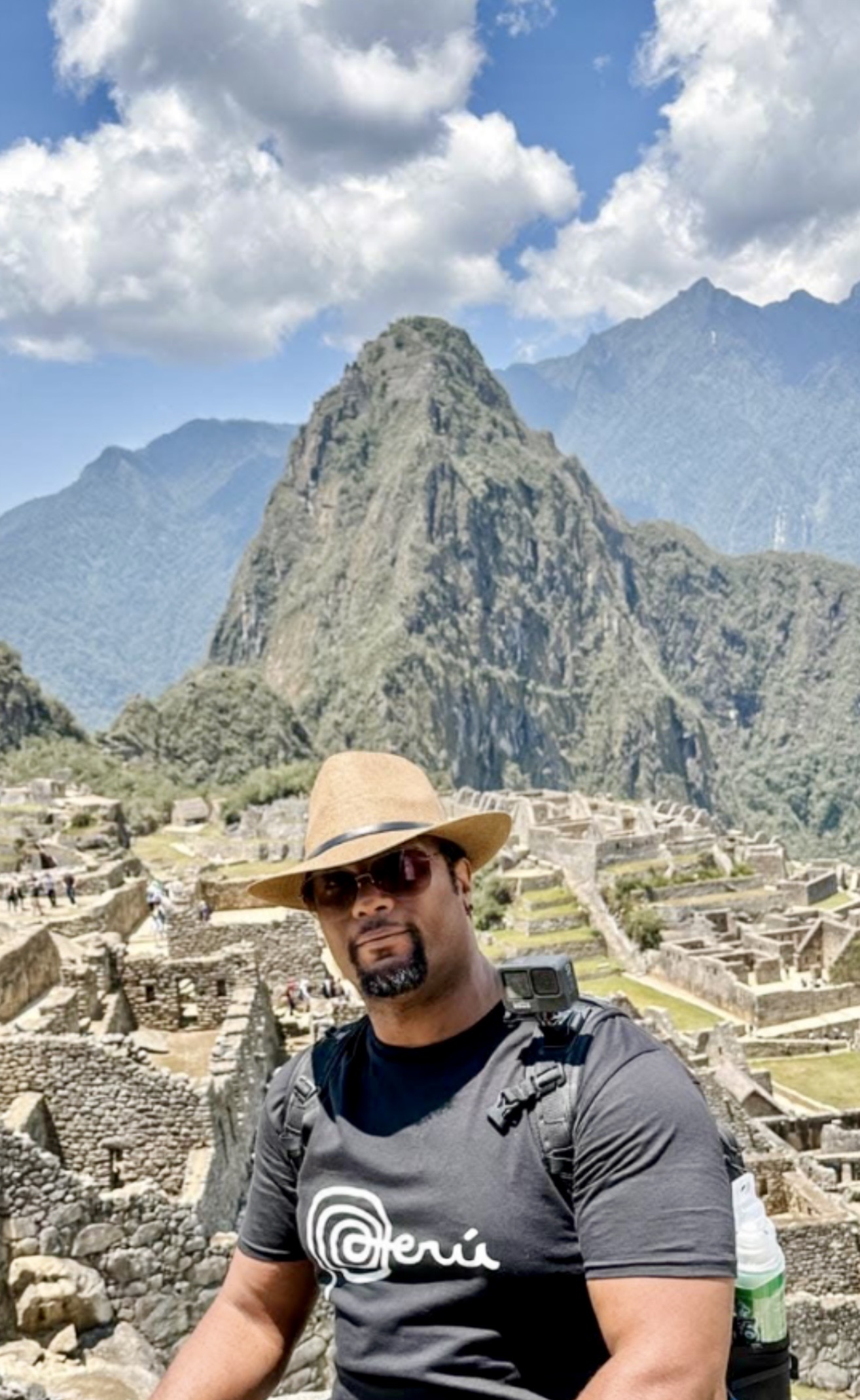 Keith Alexander standing in the Sacred Valley with the Andes mountains in the background
