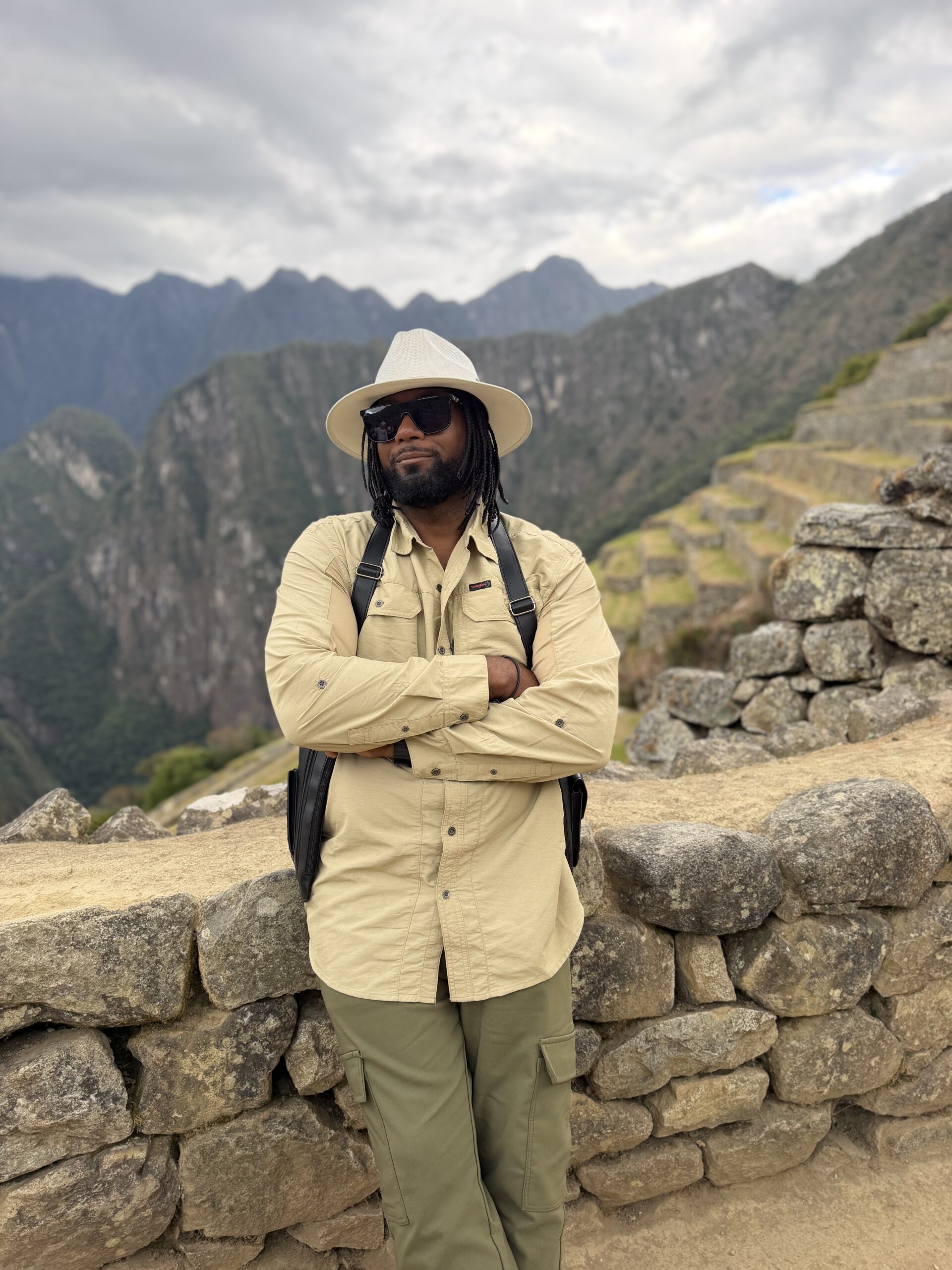 Keith Alexander standing in the Sacred Valley with the Andes mountains in the background